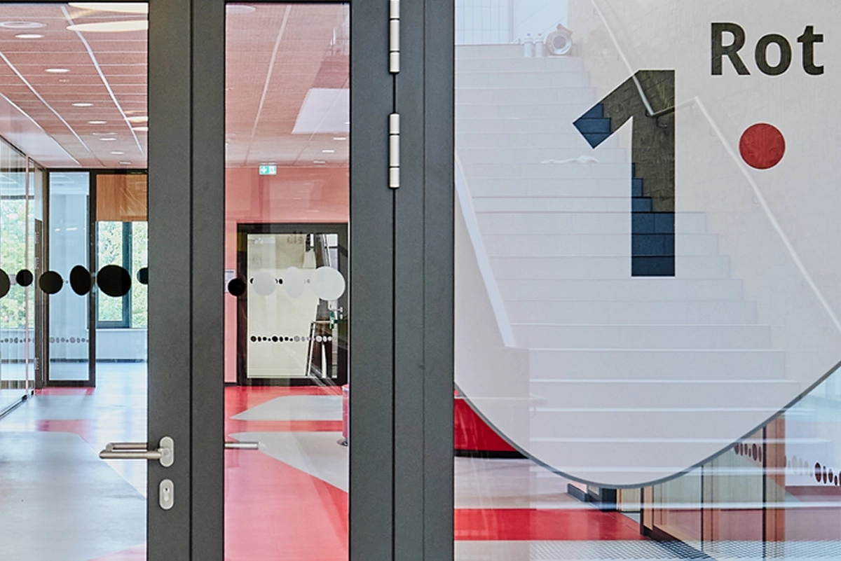 Interior shot of the Waldschlösschen Comprehensive School in Velbert, showing sections of the newly developed signage system. Implemented in collaboration with Goldbeck West and the R211 agency.