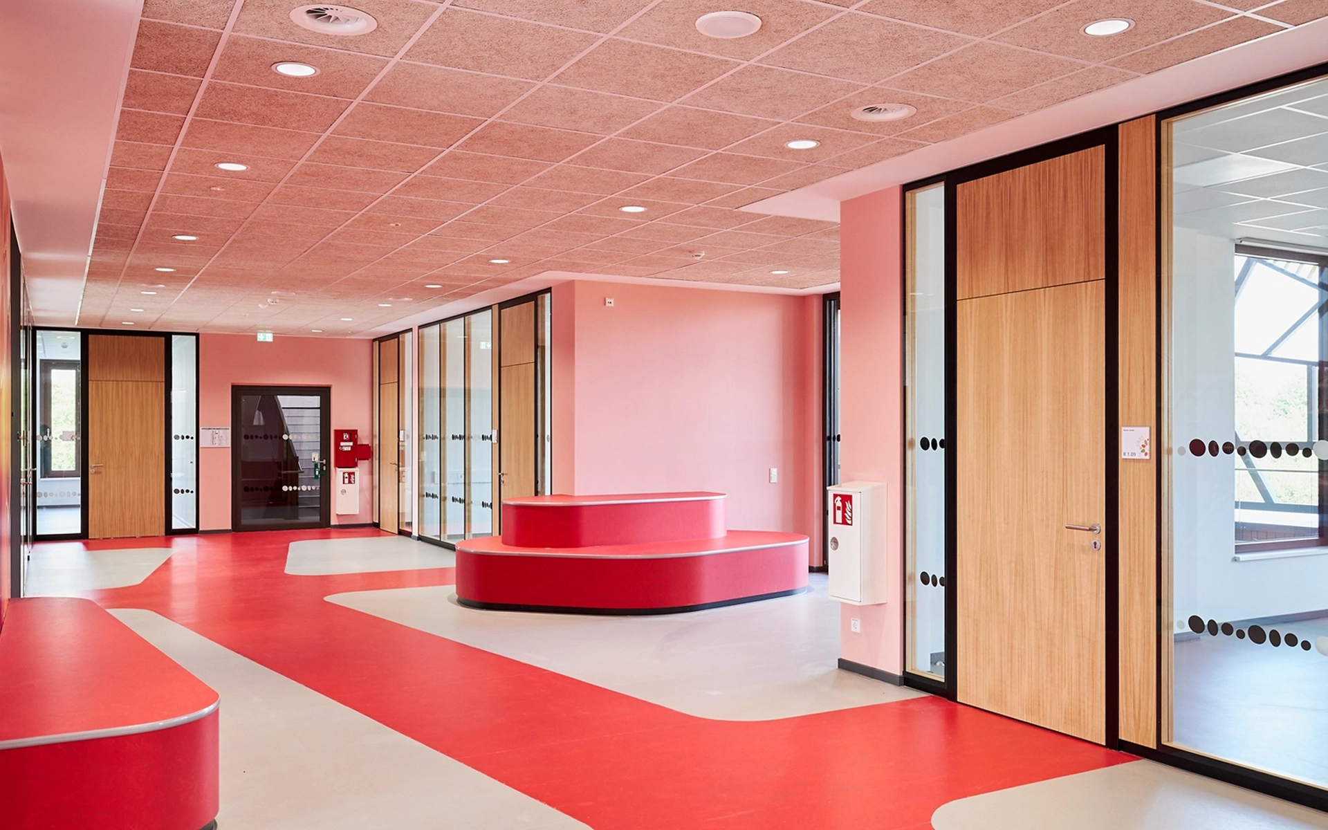 Interior shot of the Waldschlösschen Comprehensive School in Velbert, showing sections of the newly developed signage system. Implemented in collaboration with Goldbeck West and the R211 agency.