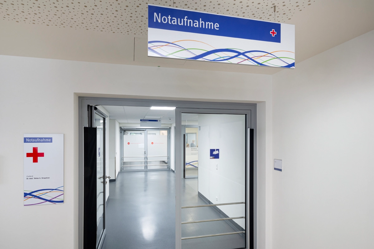 Interior shot of the Mönchengladbach Municipal Hospital with modern signage to the emergency room. Signage concept and implementation by the R211 agency.