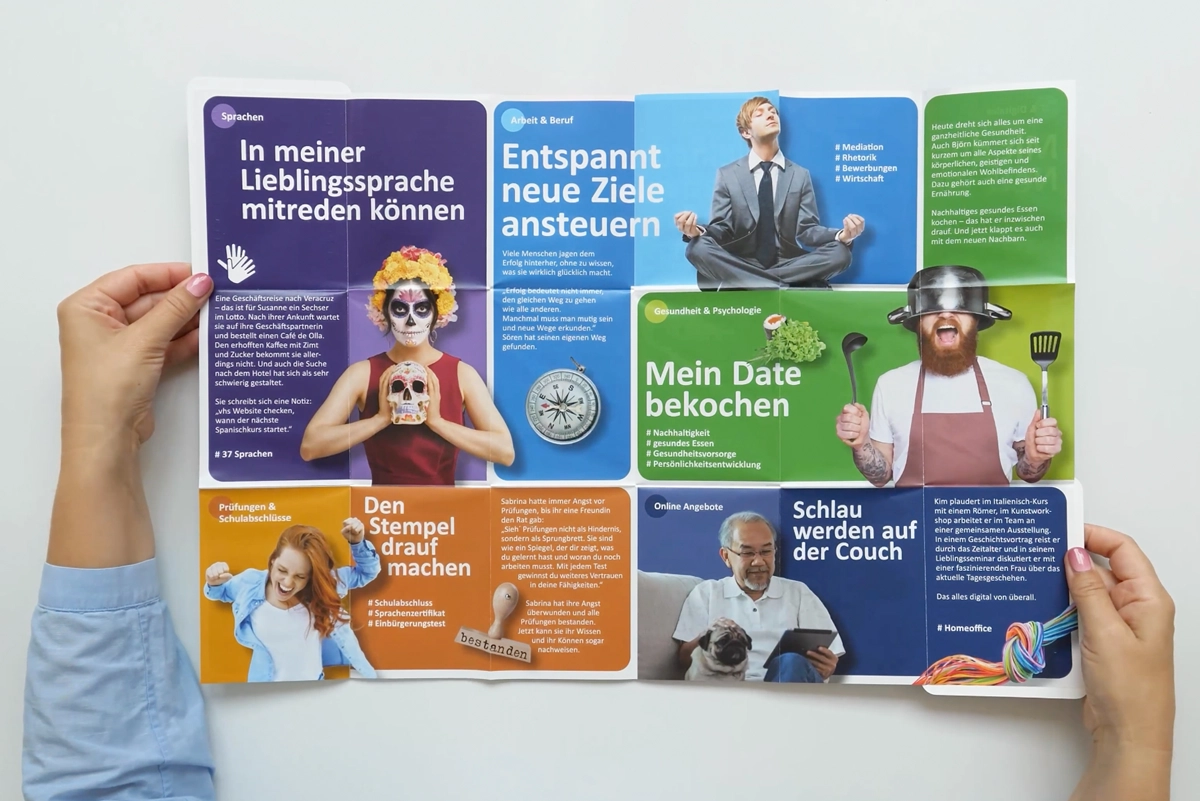 Photo of an unfolded brochure from vhs Düsseldorf with a program overview – designed for a clear presentation of the course offerings.