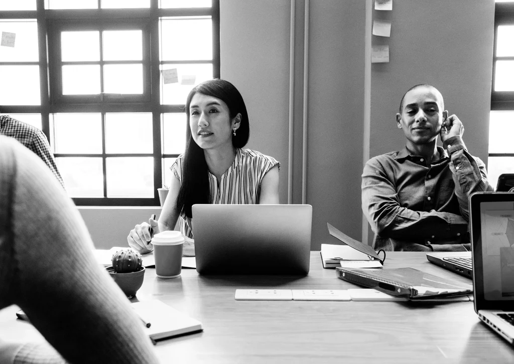 A group of people sits in a meeting
